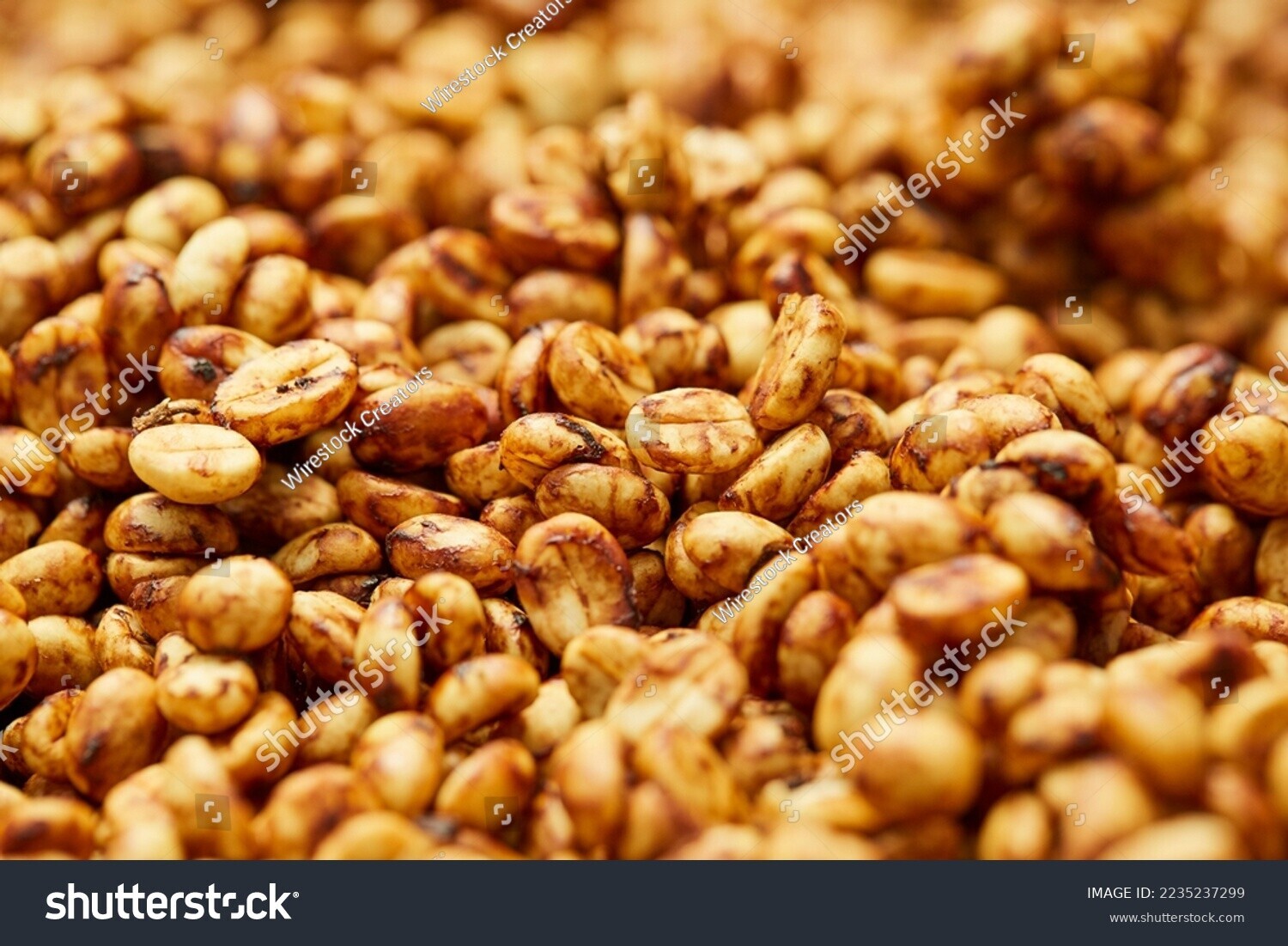 stock-photo-a-close-up-shot-of-a-pile-of-raw-fresh-coffee-beans-during-the-honey-processing-2235237299